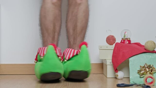 Funny elf feet dancing on a wooden floor, celebrating the holidays with christmas gifts and decorations in the background, bringing joy and a festive mood to the season with happy moves