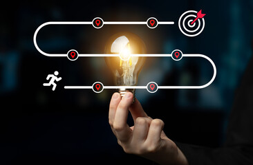 Fototapeta premium This image illustrates a vibrant concept of journey towards achievement, showcasing a light bulb representing ideas, progress, and the target for successful goal completion. Ledger