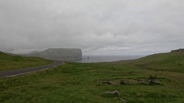 Distant view of Risin og Kellingin sea stacks from a mountain road, Faroe Islands