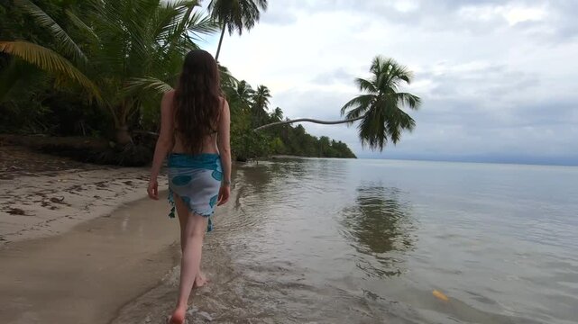 Young Woman Walking Along a Tropical Caribbean Beach at Sunset in Bocas del Toro, Panama