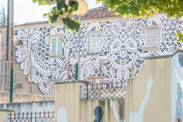 Building facade with black and white patterned mural in Portugal © Elsworth Frobisher