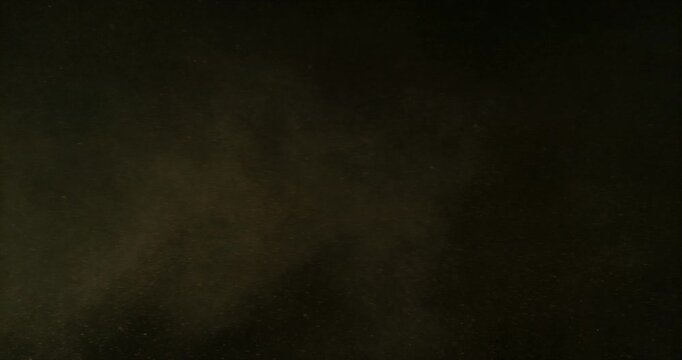 Super slow motion sandstorm and dust blizzard effect with airborne sand and fine particles, filmed at 500 fps on a high-speed camera. Isolated on black background, ideal as realistic VFX overlay.