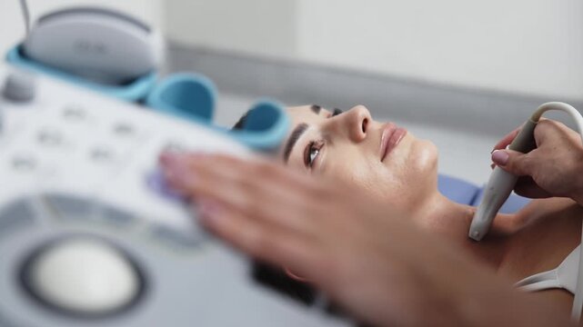 Young female patient lying on an examination table during a thyroid ultrasound procedure. Concept thyroid examination, ultrasound diagnostics, endocrinology, medical care, preventive healthcare.