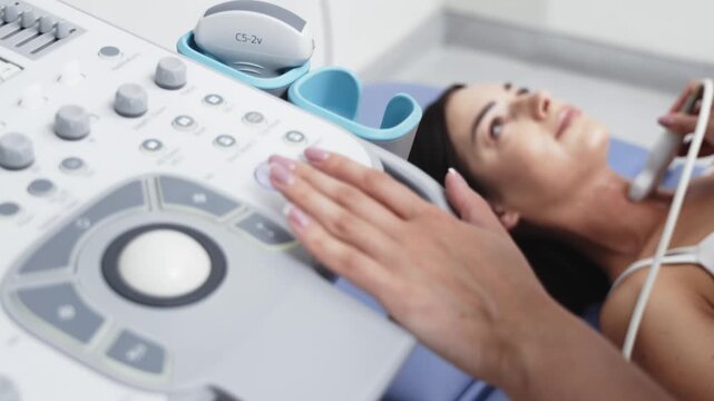 Young woman receiving a thyroid ultrasound examination in a modern healthcare clinic. Concept thyroid health, endocrinology, ultrasound diagnostics, preventive medicine, healthcare.