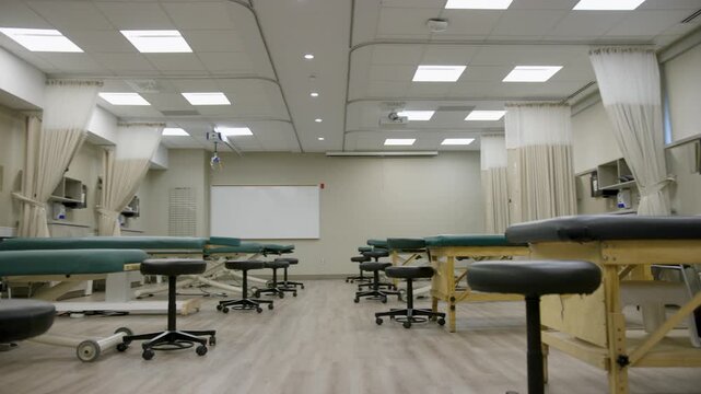 Modern Physical Therapy Training Lab with Treatment Tables and Medical Equipment