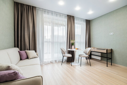 Living space in a modern apartment with a dining area and natural light
