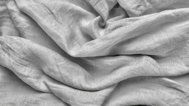 silver linen fabric draping in elegant soft folds creates a serene minimalist textured background for luxury design