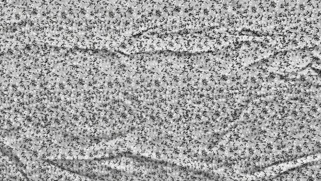 monochrome ditsy floral print fabric background showing delicate creased cotton textile texture