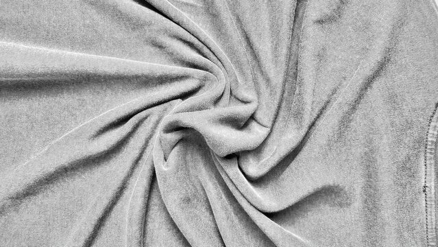 soft grey velvet fabric swirl with elegant draping and fine ribbed texture for abstract background