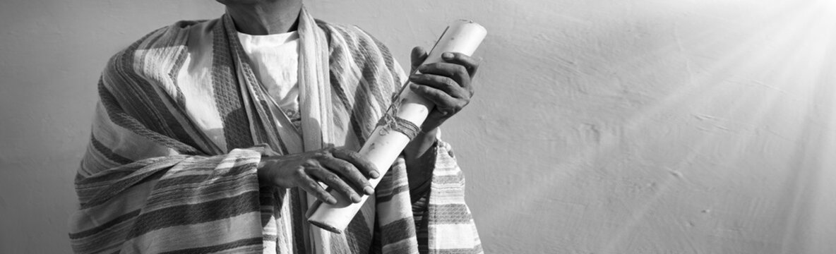 Male hand holding an old scroll