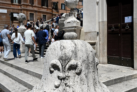 panoramic view of the famous stairs in Rome, Italy with blurred tourists. popular landmark monument and attraction. carved white stone sculpture in closeup view. wide stairs beyond. travel and tourism