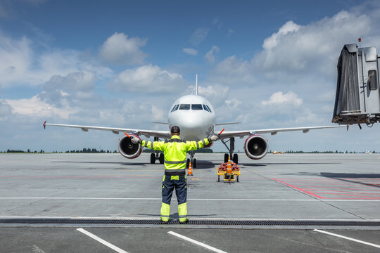 Aircraft marshalling at the airport. Passenger airplane meeting