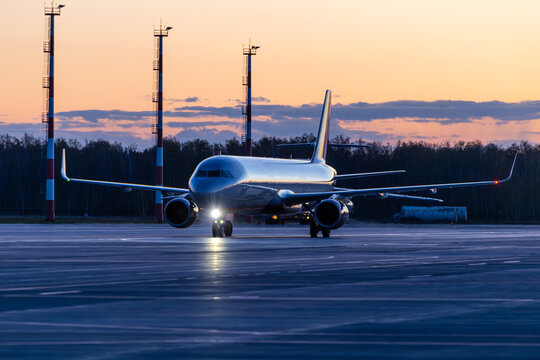 Modern passenger aircraft taxiing at the airport early in the morning