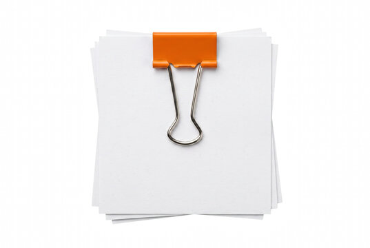 White note paper stack fastened with an orange binder clip