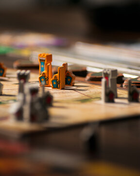 Portrait macro product photography of Lord of the Rings Duel Middle Earth showing fantasy map with wooden warrior orc and tower pieces designed by Antoine Bauza and Bruno Cathala