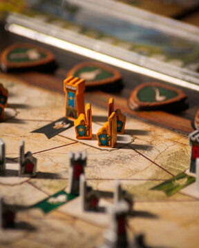 Portrait macro product photography of Lord of the Rings Duel Middle Earth showing fantasy map with wooden warrior orc and tower pieces designed by Antoine Bauza and Bruno Cathala
