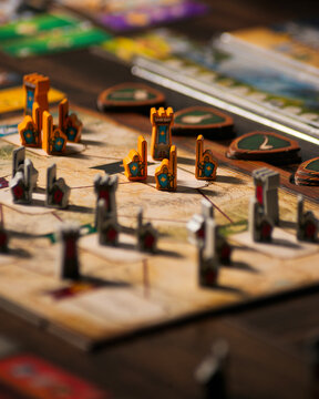 Portrait macro product photography of Lord of the Rings Duel Middle Earth showing fantasy map with wooden warrior orc and tower pieces designed by Antoine Bauza and Bruno Cathala