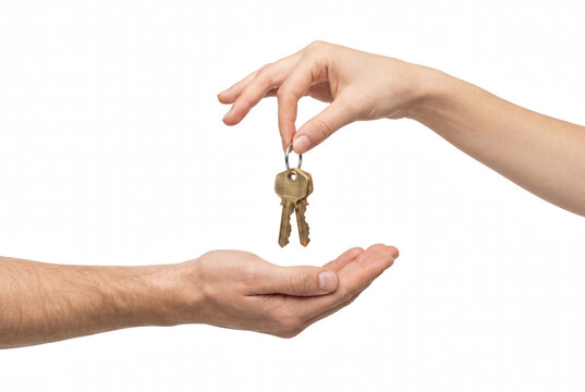Person Handing Over Brass Keys to Another Person