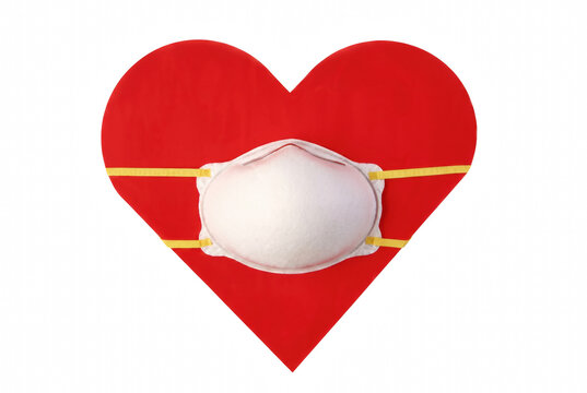 Protective Face Mask Placed Over Large Red Heart Shape