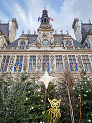Obraz premium Paris, France - December 10, 2025: Hotel de Ville in Paris during the winter holidays decorated with Christmas trees and festive lights