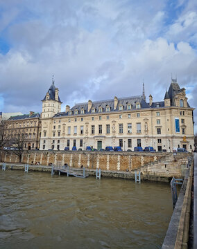 Paris, France - December 10, 2025: Tribunal Correctionnel de Paris (Conciergerie) situated along the Seine River. The grand stone building with pointed turrets sits behind a high quay wall