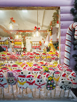 Chisinau, Moldova - January 10, 2026: A festive market stall with vibrant wrapped lollipops shaped like snowmen. Charming Christmas holiday confectionery atmosphere