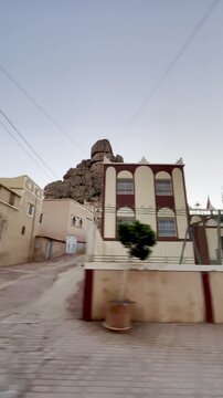Aguerd, Tafraout, Morocco &ndash; May 31, 2026: Driving through the peaceful streets of Aguerd village beneath the famous Napoleon's Hat granite formation in the Anti-Atlas Mountains.
