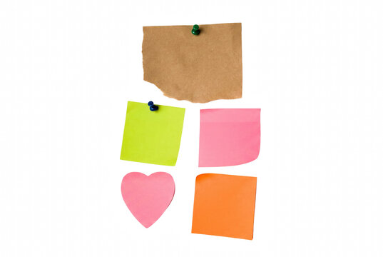 Colorful sticky notes and torn kraft paper arrangement with push pins