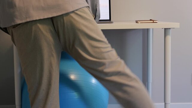 Middle Aged Man IT Band Physical Therapy Standing Desk Exercises Working From Home Remote - Sedentary Office Occupations - Sitting Harms Desk Staff