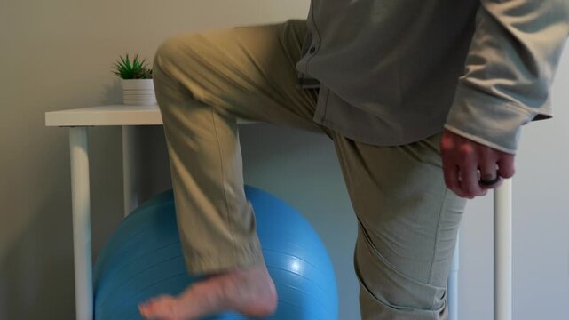 Middle Aged Man IT Band Physical Therapy Standing Desk Exercises Working From Home Remote - Sedentary Office Occupations - Sitting Harms Desk Staff