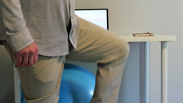 Middle Aged Man IT Band Physical Therapy Standing Desk Exercises Working From Home Remote - Sedentary Office Occupations - Sitting Harms Desk Staff