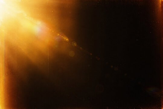 Sunlight streams through dusty window blinds creating dramatic beams of light across room.