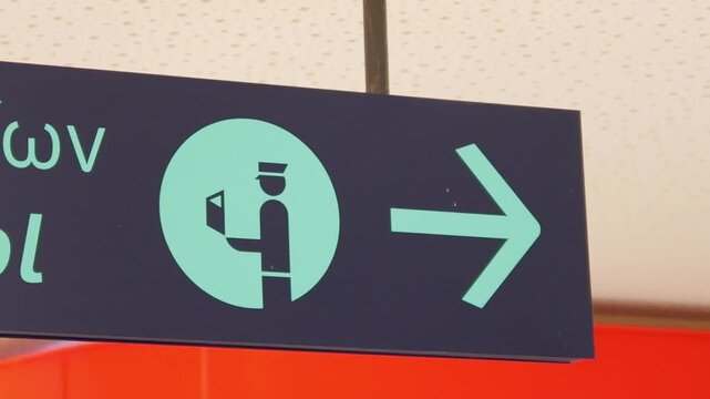 Greek airport sign for passport control with directional arrows in slow motion 60fps