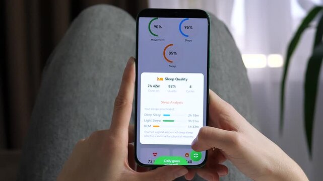 User reviewing a comprehensive sleep analysis on a health app. Deep sleep, light sleep, and REM stages are clearly visualized. Ideal for sleep tracking, wellness technology, and circadian rhythm stock