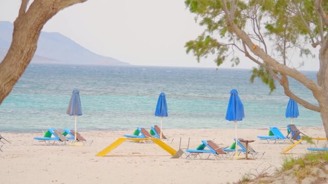 A beach on Kos island with sunbeds and umbrellas in slow motion 60fps