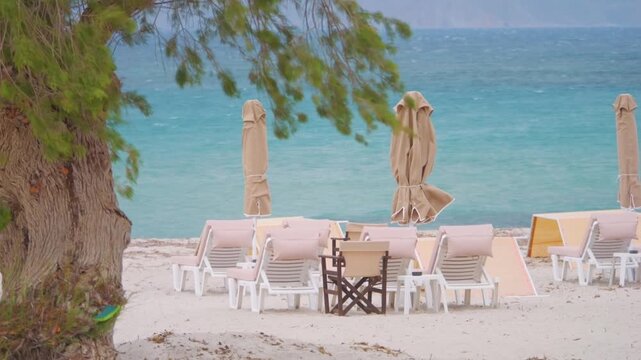 A beach on Kos island with sunbeds and umbrellas in slow motion 60fps