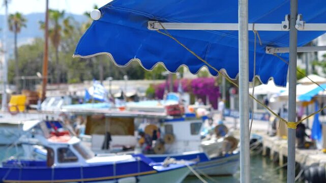 A busy harbor area in Kos island with people and boats in slow motion 60fps