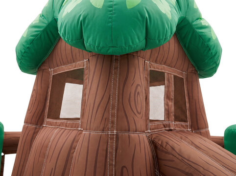 Inflatable tree house bounce house play structure with brown wood grain bark texture and green leafy canopy on black background for backyard children party playground and outdoor fun.