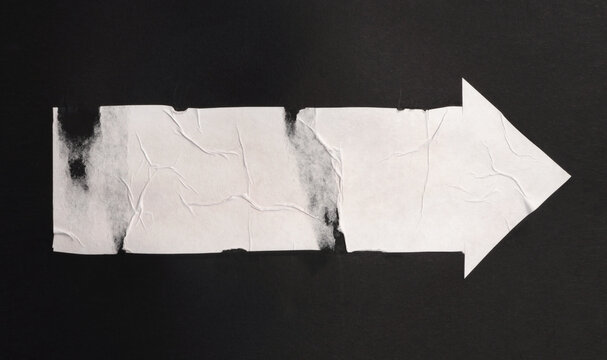 Torn, ripped paper pieces wave crack crumbled arrow collage. Black and white grunge copy space texture wrinkle poster background.