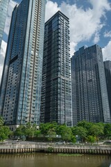 Fototapeta premium Modern glass skyscrapers along canal at 2 Ton Duc Thang waterfront development, District 1, Ho Chi Minh City, Vietnam