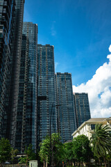 Fototapeta premium Low-angle architectural view of modern dark glass skyscrapers at 2 Ton Duc Thang development, Ho Chi Minh City, Vietnam