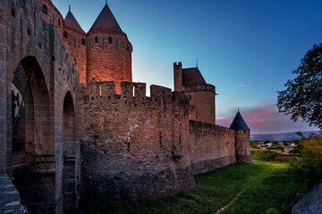 Historic castle in Carcassonne during sunset with towers and walls © Andrew