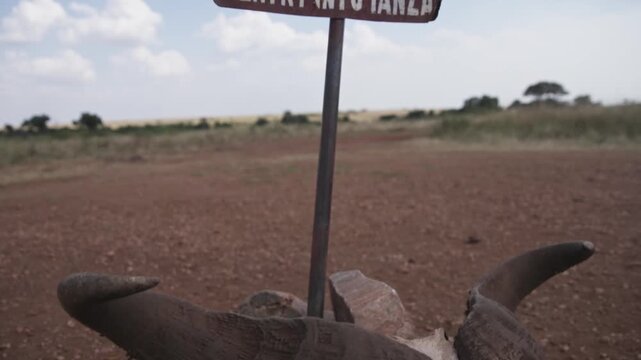 No entry to Tanzania international boundary signage at Kenya border between Maasai Mara national park reserve and Serengeti wildlife tourist area for crossing on foot