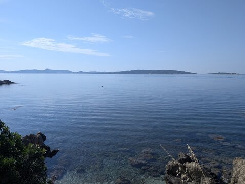 Calm blue Mediterranean Sea with distant islands on the horizon viewed from Giens, France.