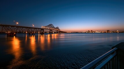 Obraz premium Bridge across the Columbia River at dusk in the Tri-Cities region, city lights reflected on calm water