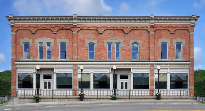 Old fashioned American small town main street building with ornate brick decorations and roof cornice