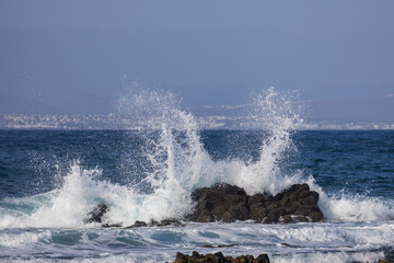 Naklejka premium Dramatic Powerful Atlantic Ocean Wave Crash and Spray Over Volcanic Rocks, Fuerteventura