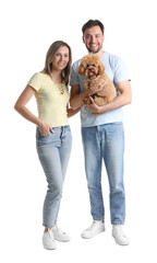 Fototapeta premium Happy couple and their cute dog on white background