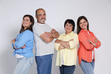 Fototapeta premium Happy family. Twin sisters and their parents on light background