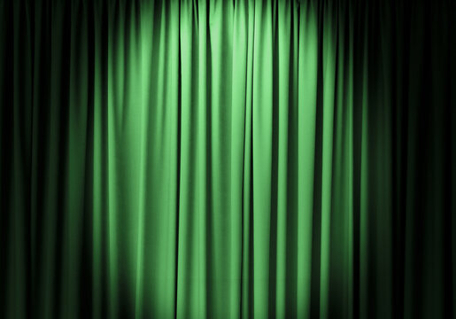 Green curtain with spotlight as background, closeup